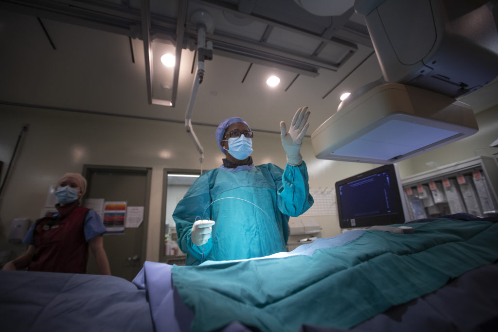 Doctor performing MII with nurse in background
