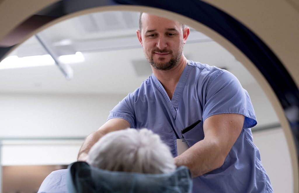 Doctor Guiding Patient through CT scan