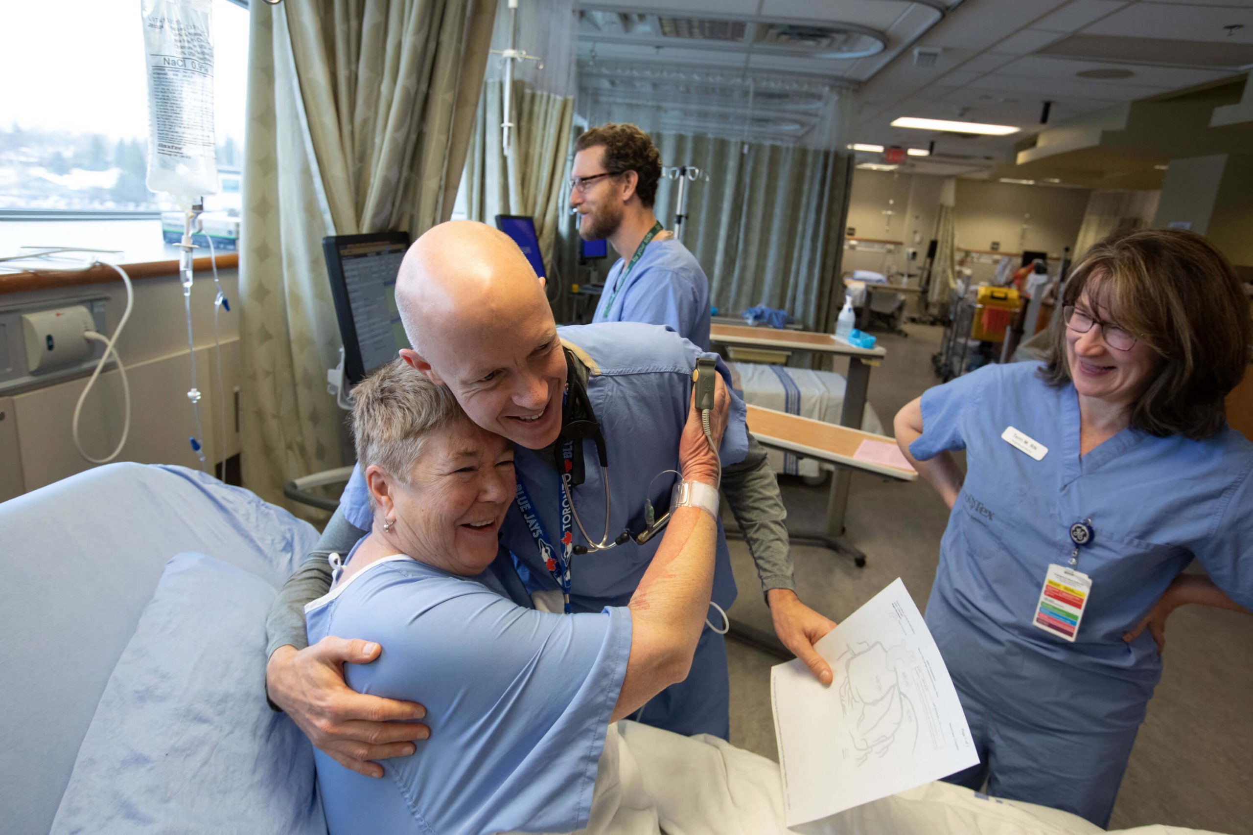 Cardiac doctor hugging patient at bedside