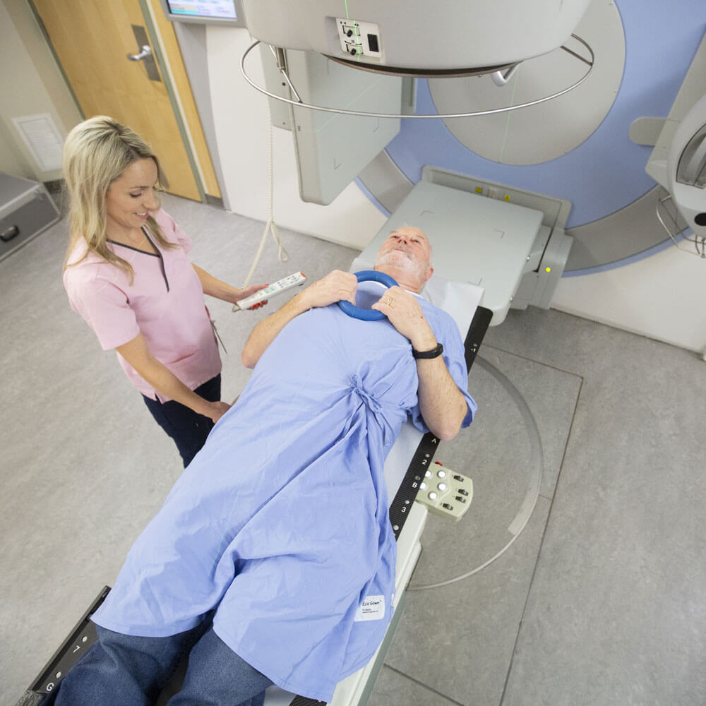 Patient undergoing a digital imaging scan with technician guidance