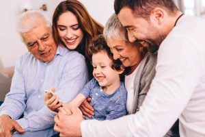 Child closely embraced by parents and grandparents