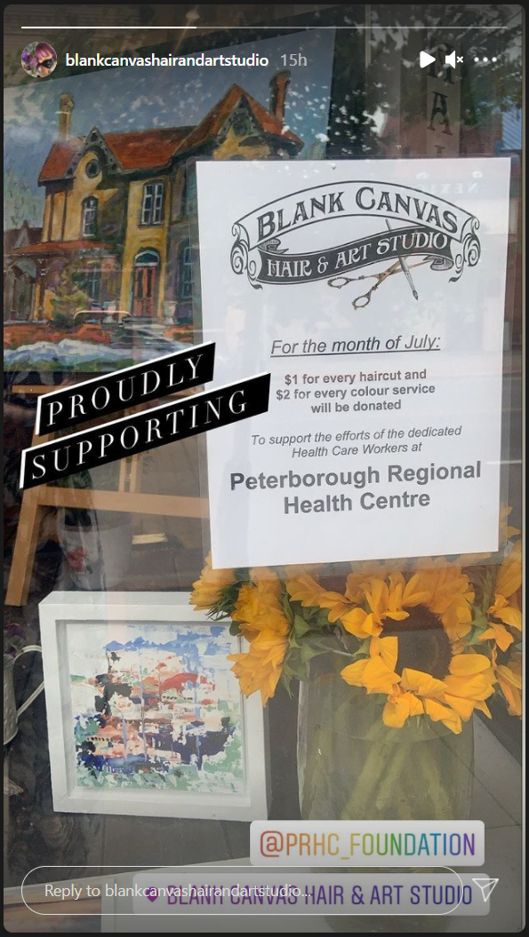 A window sign advertises a hair and art studio's fundraiser for the PRHC Foundation