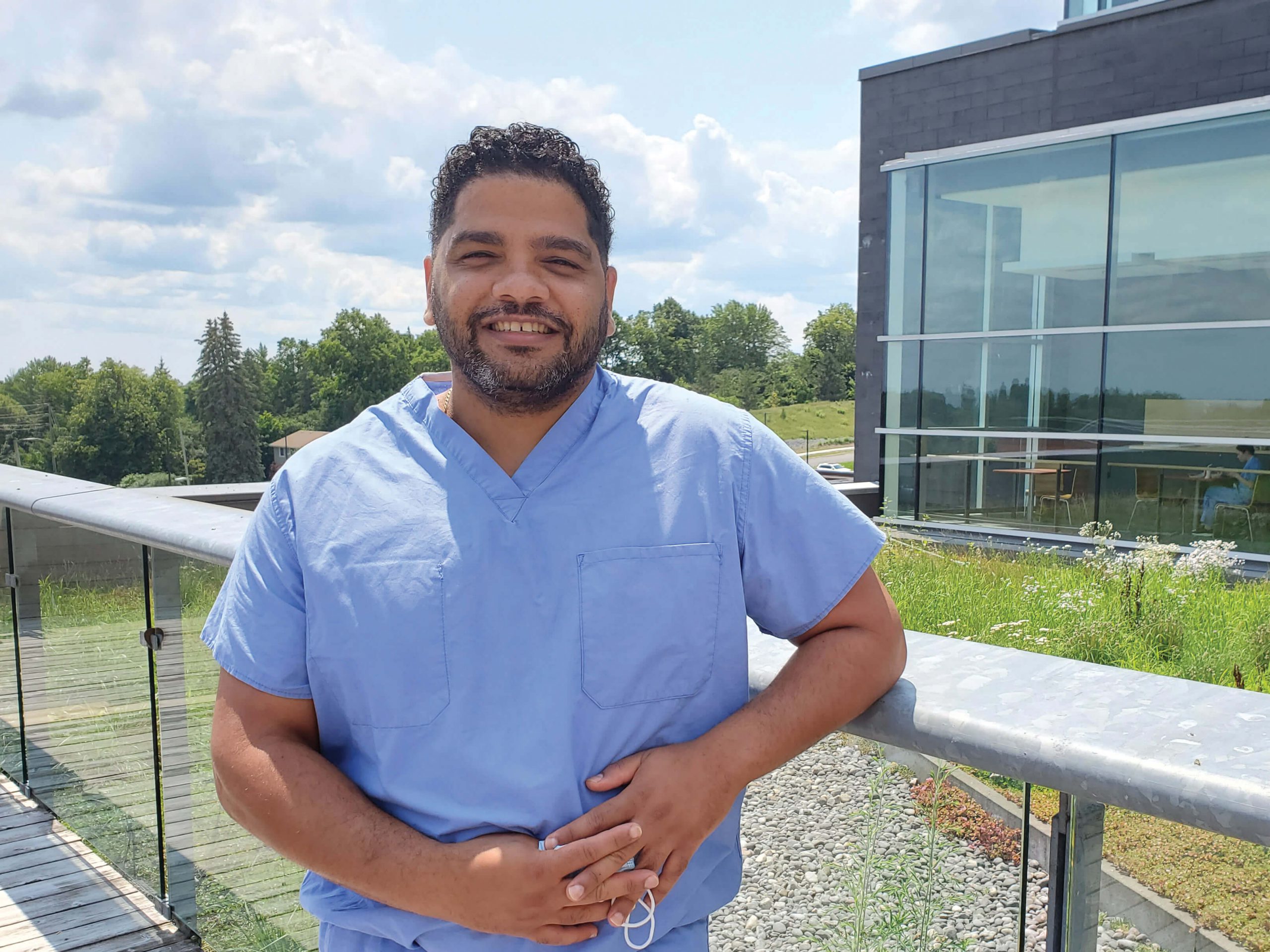 A doctor poses outside the hospital