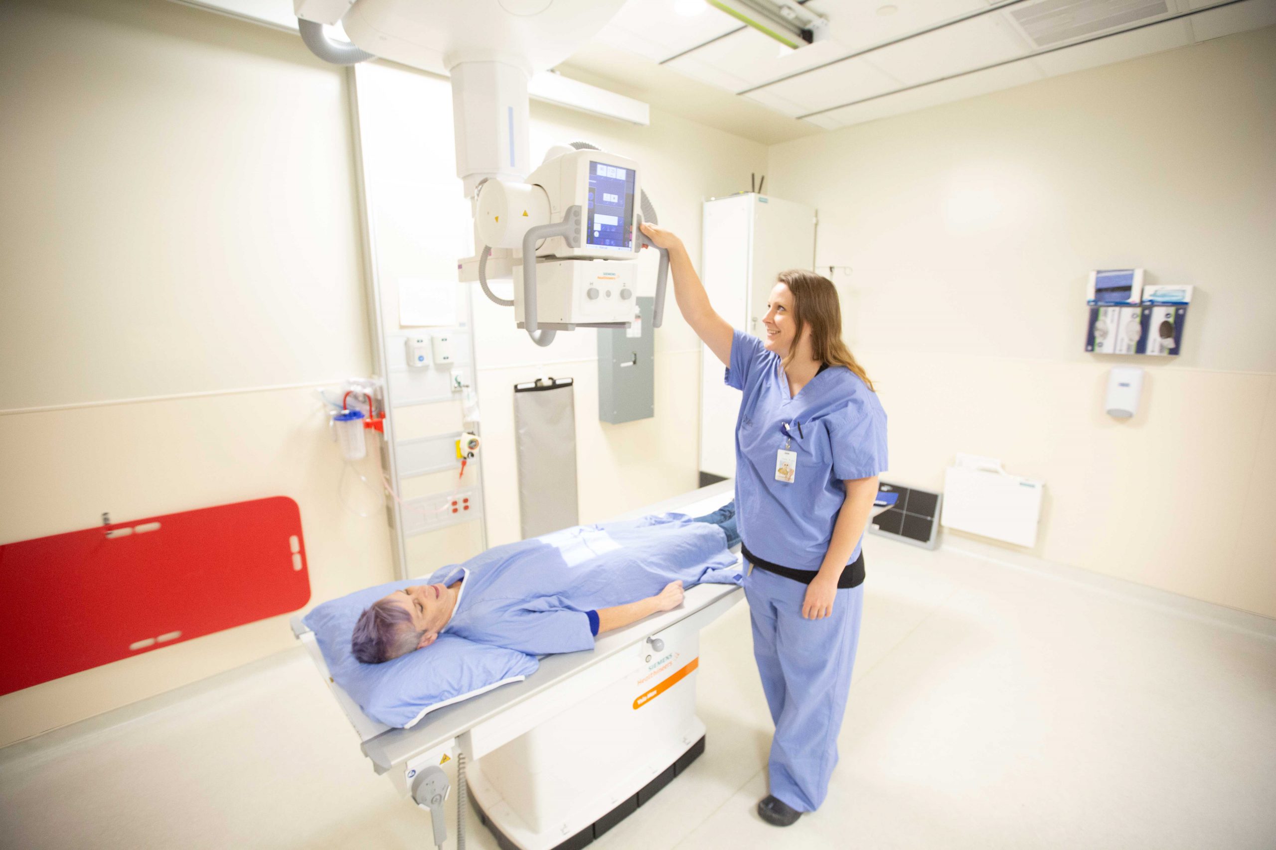 A medical radiation technologist prepares to X-Ray a patient