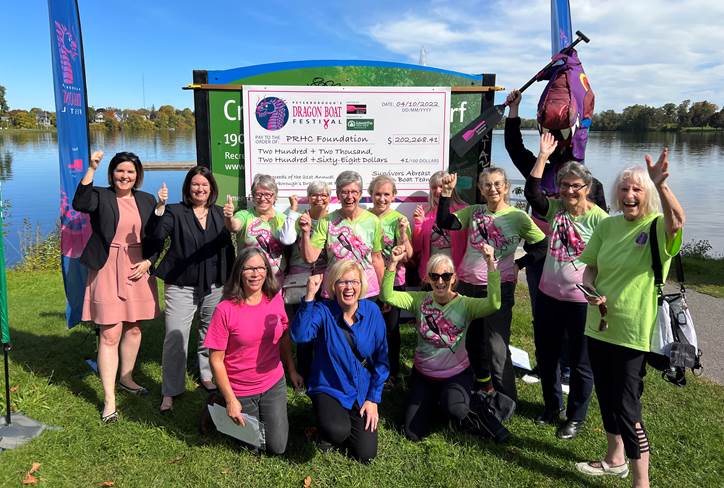 Group of Dragon Boat paddlers with giant cheque