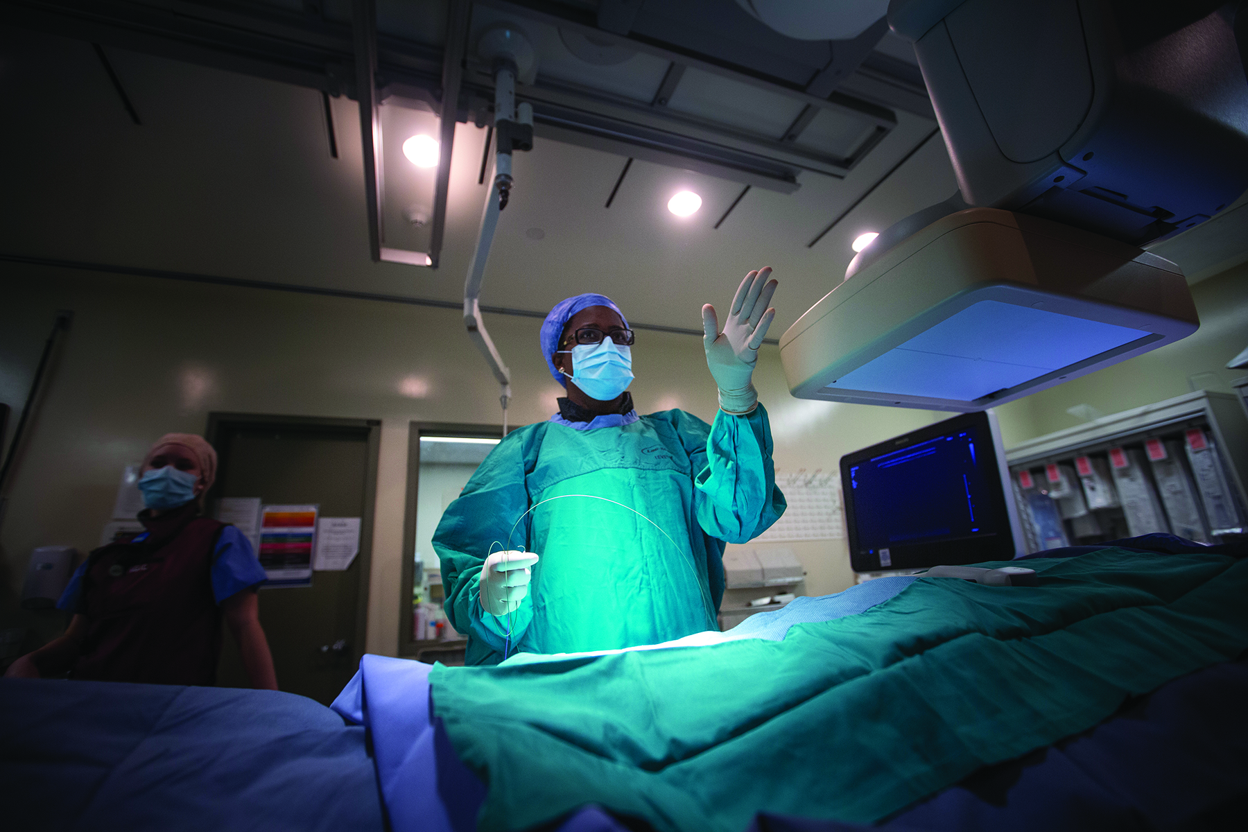 A doctor performs a minimally invasive interventional radiology procedure.
